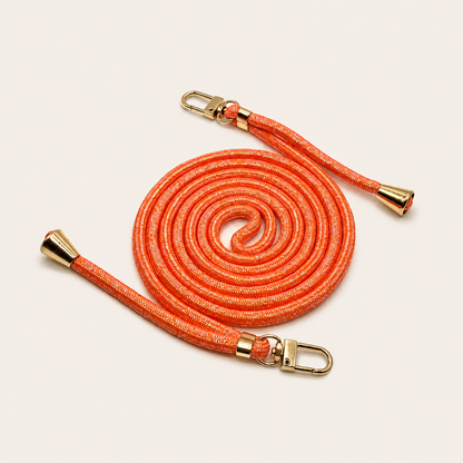 Orange Shimmery PHONE CORD with a metallic sheen, coiled with gold hardware, shown as a flat lay.