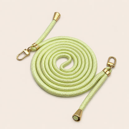 Pale green Shimmery PHONE CORD with a metallic sheen, coiled with gold hardware, shown as a flat lay.