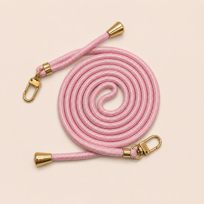 Pink Shimmery PHONE CORD with a metallic sheen, coiled with gold hardware, shown as a flat lay.