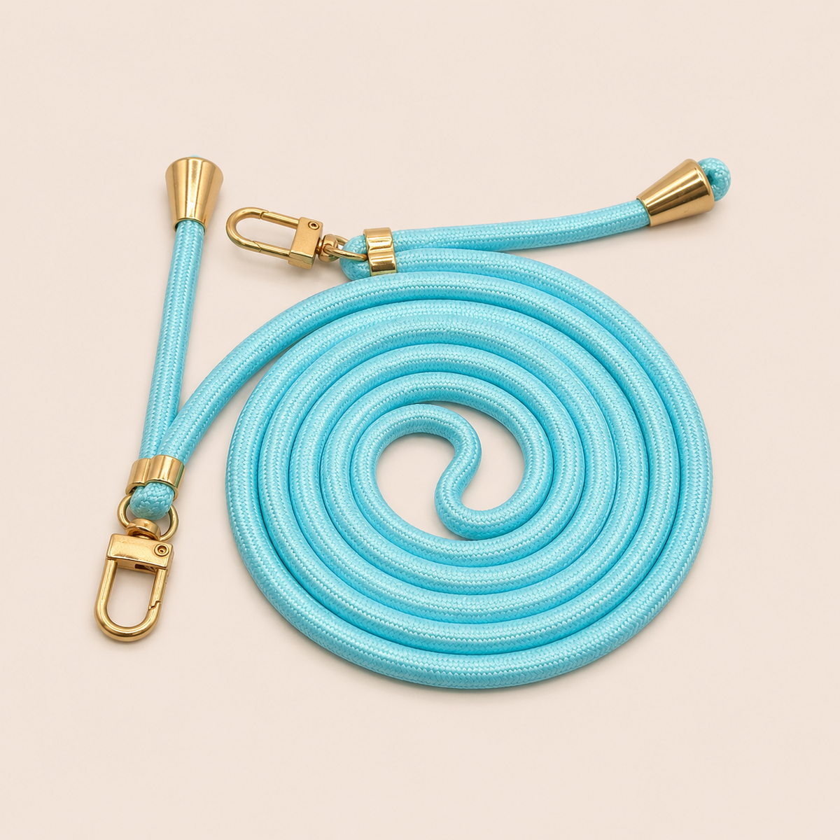 Light blue Shimmery PHONE CORD with a metallic sheen, coiled with gold hardware, shown as a flat lay.