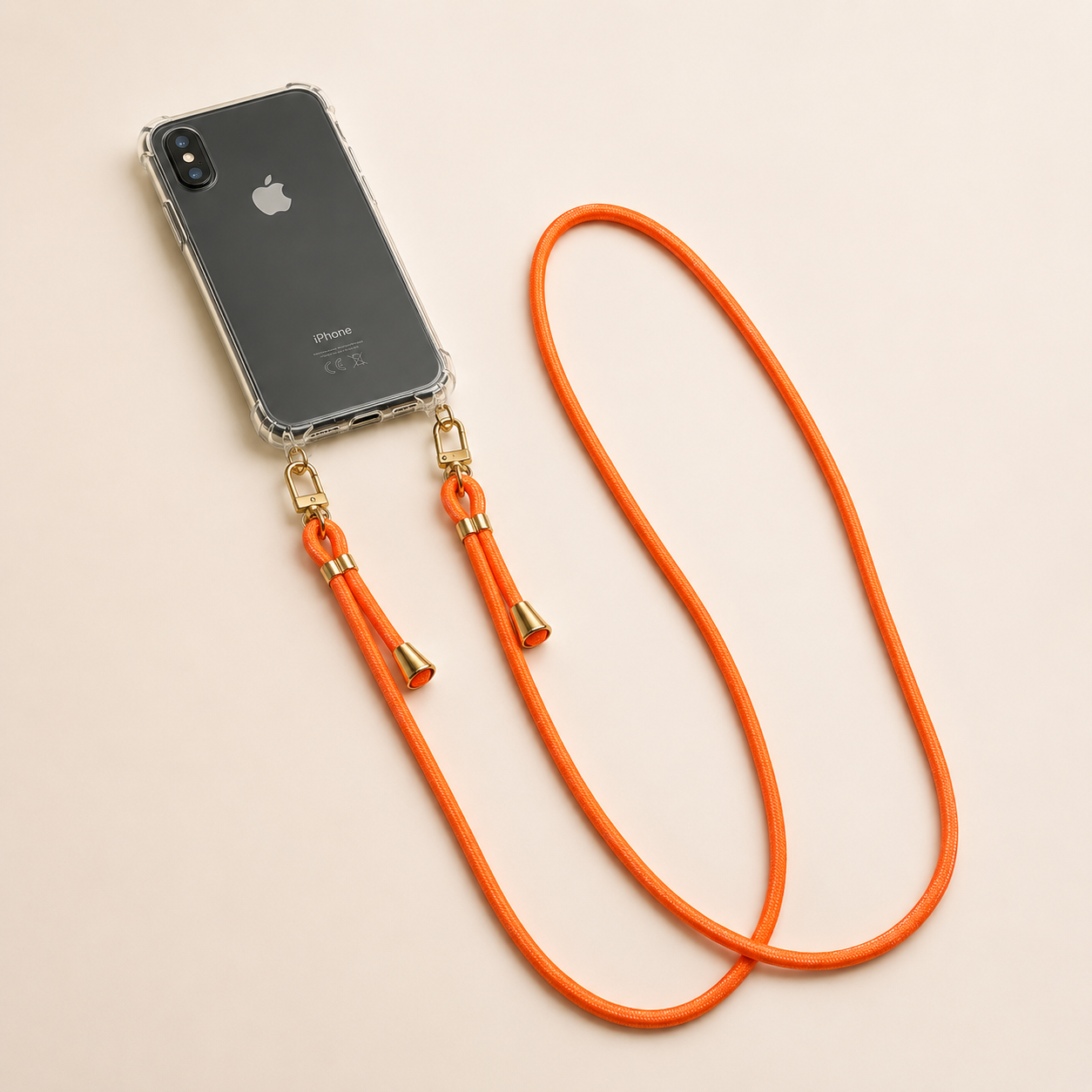 Clear iPhone case with an orange Shimmery PHONE CORD attached, shown as a flat lay.