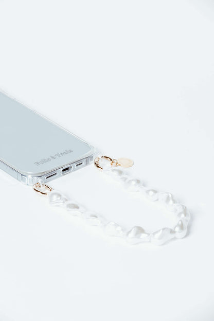Clear phone case with a baroque pearl Short Pearl PHONE STRAP shown from an angled close-up on a white background.