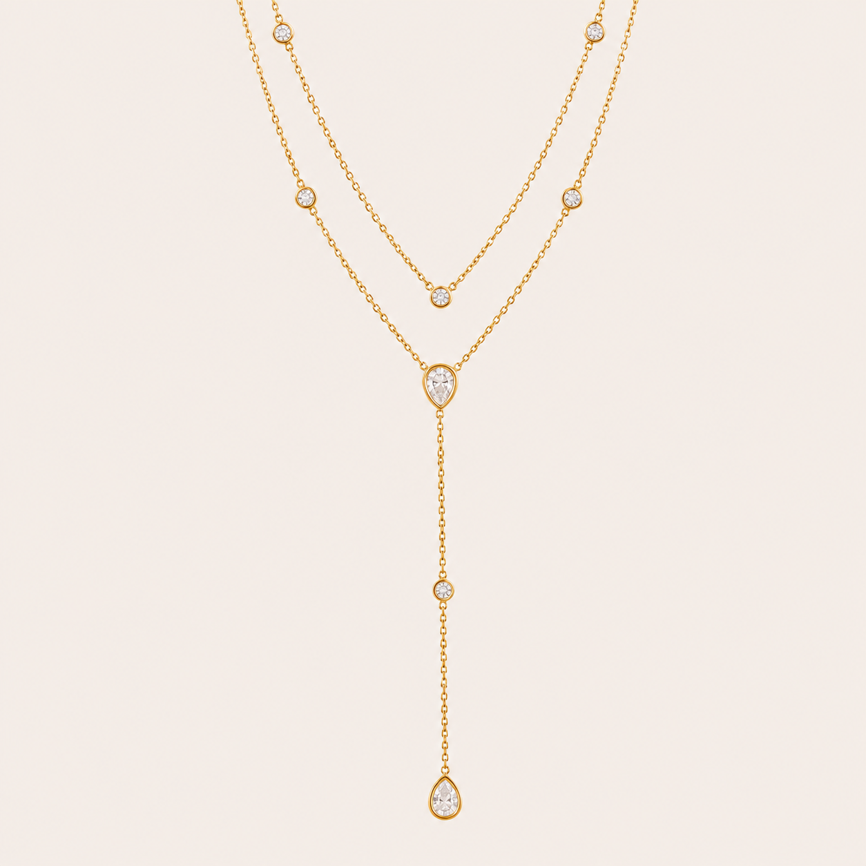 Gold Sienna Y NECKLACE with clear crystal stations drawn into a long lariat drop with pear-shaped crystal accents.