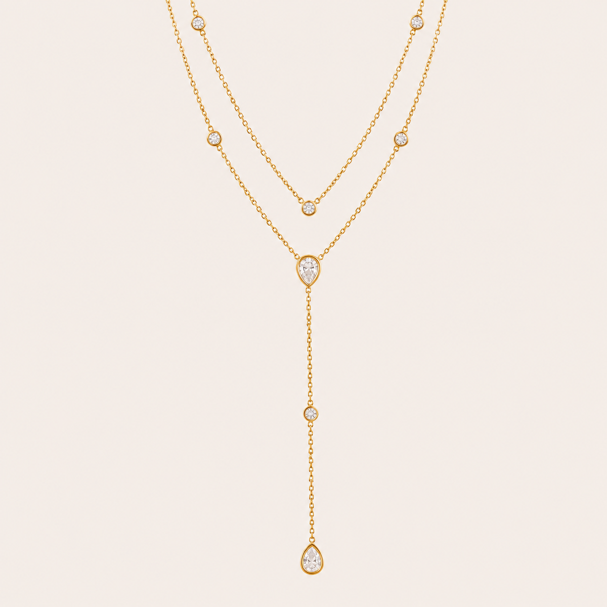 Gold Sienna Y NECKLACE with clear crystal stations drawn into a long lariat drop with pear-shaped crystal accents.