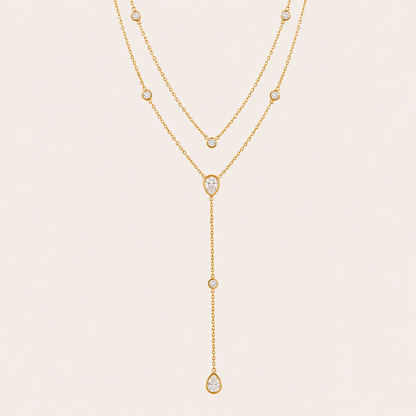 Gold Sienna Y NECKLACE with clear crystal stations drawn into a long lariat drop with pear-shaped crystal accents.