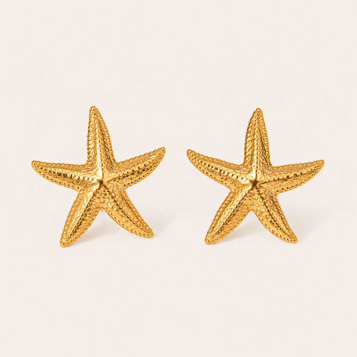 Gold textured starfish-shaped stud earring with a beaded dotted surface — Folie à Trois Siesta EARRINGS.