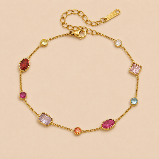 Sirena BRACELET in gold with multicolored gemstones in varied cuts and shapes set along a delicate chain, shown flat.