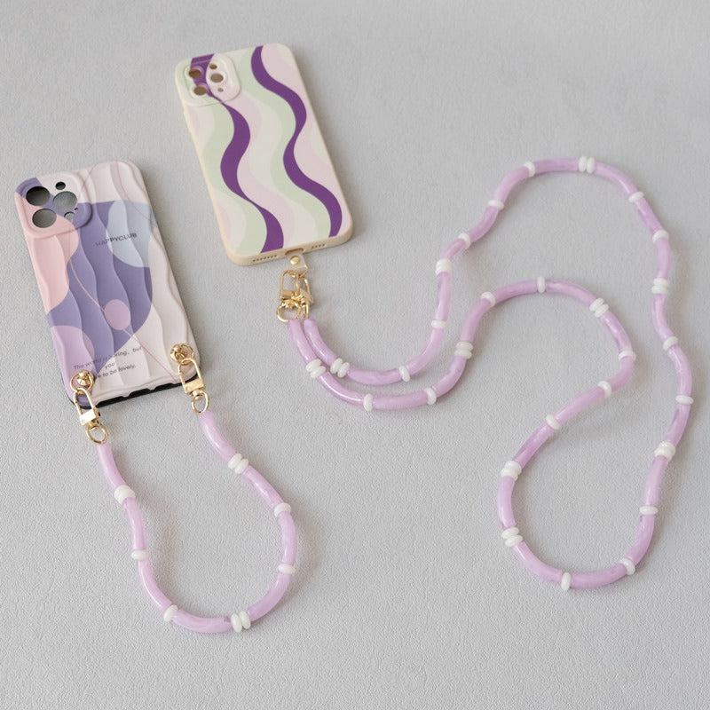 Lavender Smooth Moves PHONE CHAIN attached to two wave-patterned phone cases side by side.