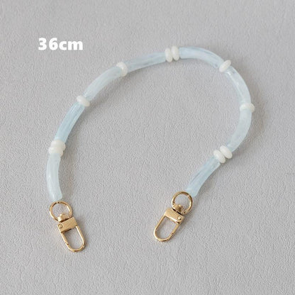Light blue Smooth Moves PHONE CHAIN, 36cm bracelet length, with gold clasps and white spacer beads.
