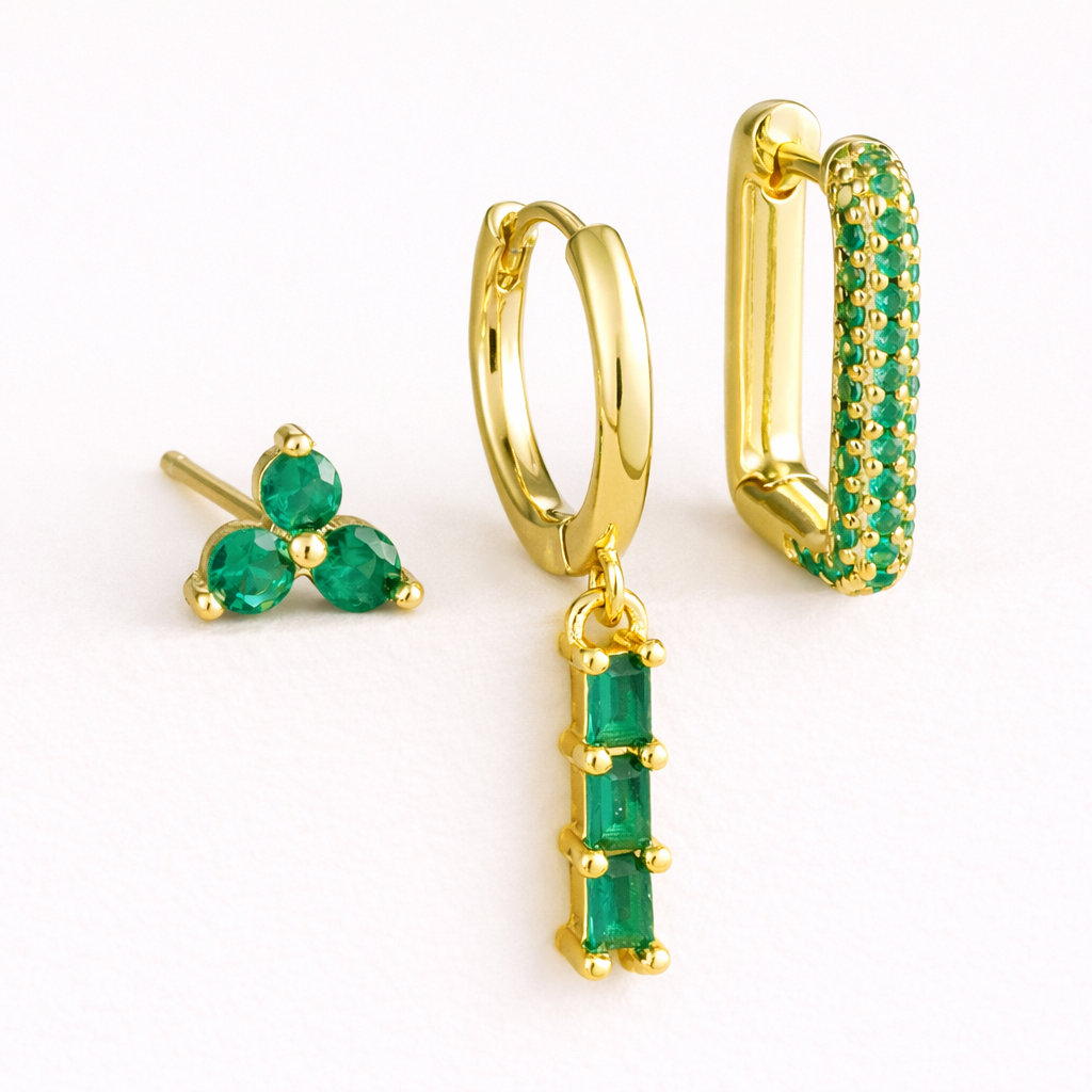The Solaire SET is shown in a green crystal colorway across its trio stud, drop huggie, and pave hoop.