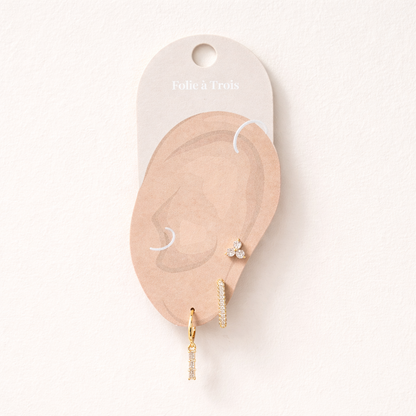 The Solaire SET is displayed on a branded card shaped like an ear, showing all three gold pieces in place.