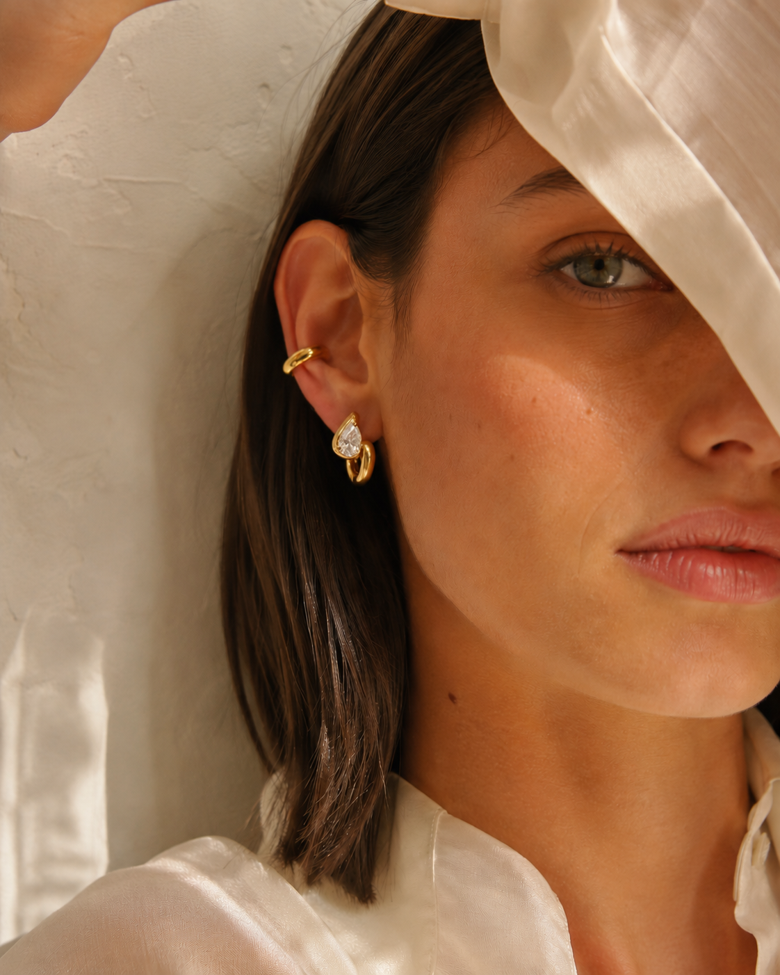 Model wears the Folie à Trois Sombra EARRINGS paired with a thin gold ear cuff, styled with a silk headscarf.