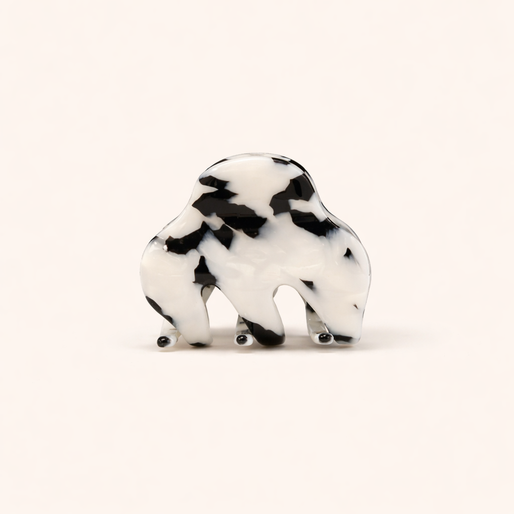 A black and white mottled tortoiseshell Soul On The Line HAIR CLIP shaped like a bison, shown on a plain background.