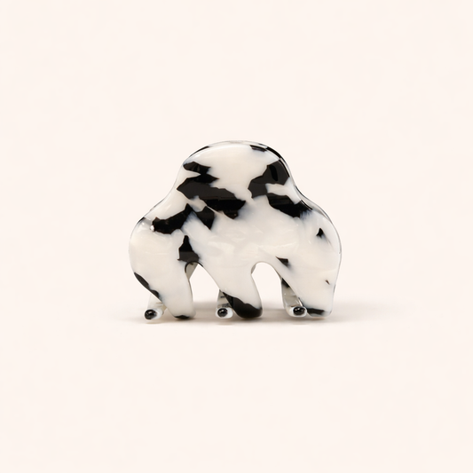 A black and white mottled tortoiseshell Soul On The Line HAIR CLIP shaped like a bison, shown on a plain background.