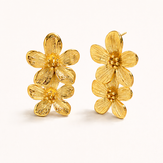 The Spring Bloom EARRINGS feature two textured gold flowers stacked vertically with detailed ridged petals.