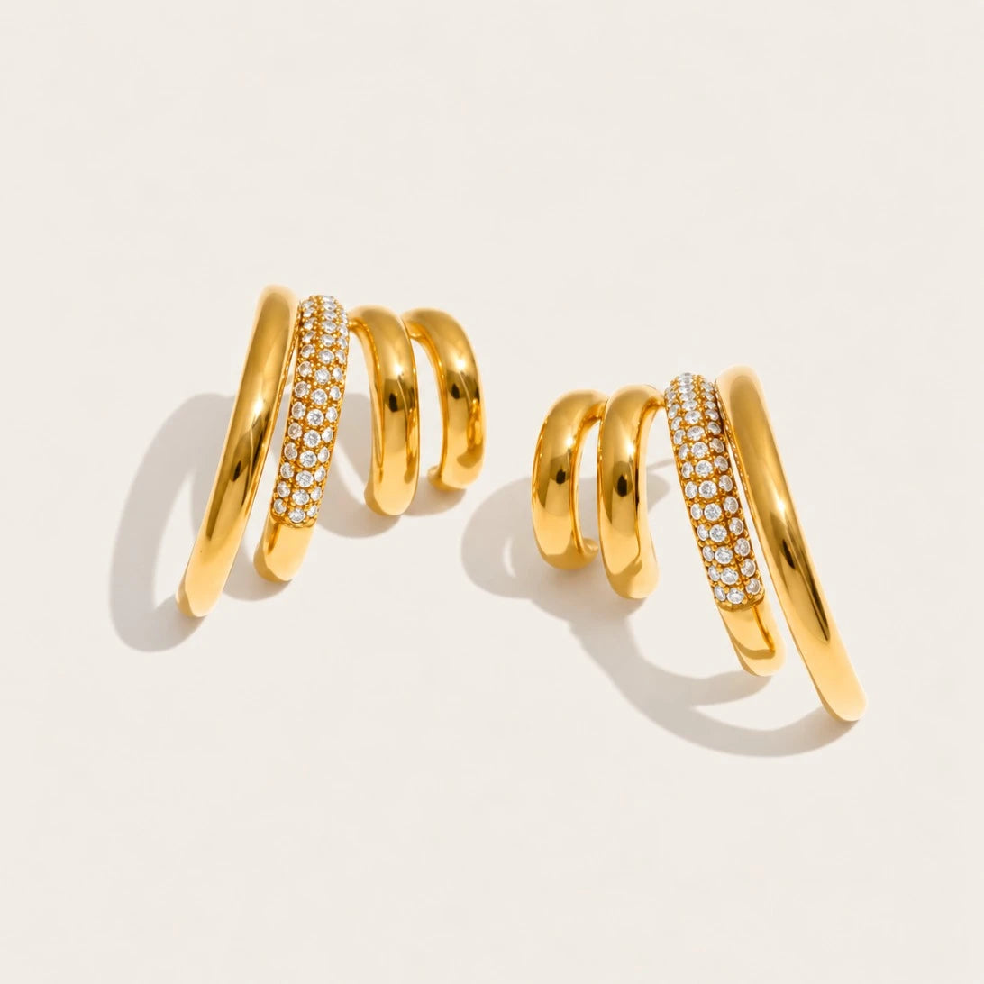 Gold Strata EARRINGS: a pair of earrings with three wavy layers, one row set with pavé white zirconia — Folie à Trois