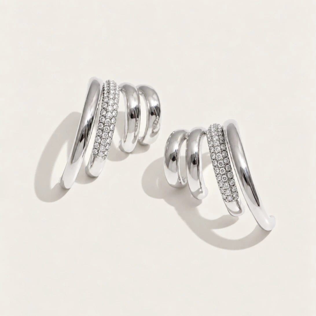 Silver-tone Strata EARRINGS: a pair of earrings with three wavy layers, one row set with pavé white zirconia — Folie à Trois