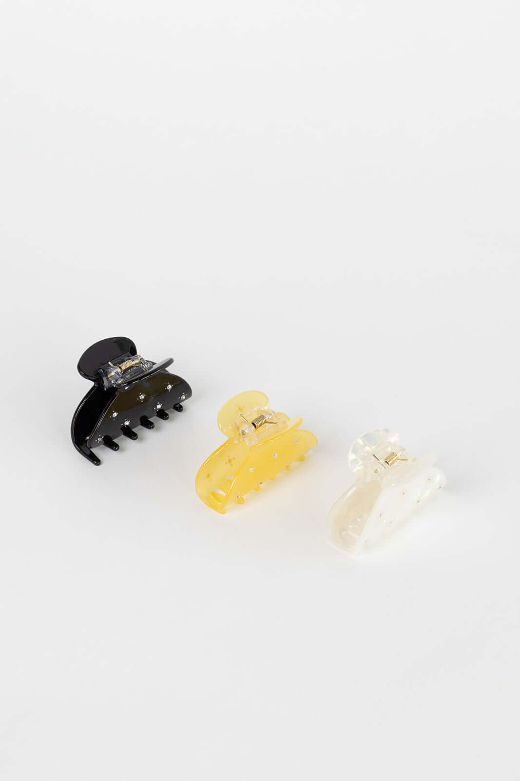 Summer Bliss HAIR CLIP three claw clips shown together in black, yellow and white colorways with crystal accents, studio shot.