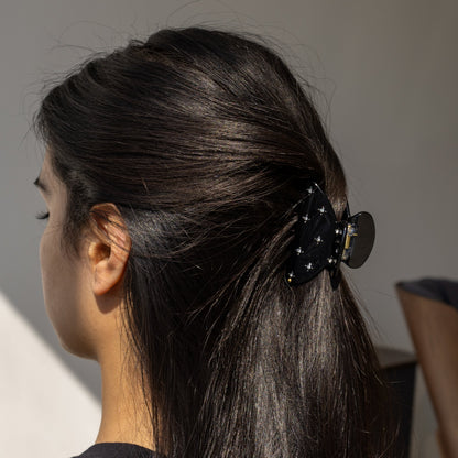 Summer Bliss HAIR CLIP in solid black, worn holding a half-up style on dark hair, back view.