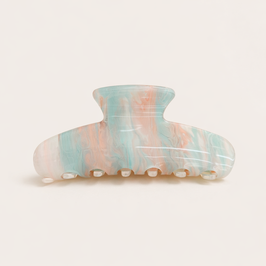 Sundae HAIR CLIP wave-shaped acetate claw clip in a pastel blue, pink and peach marbled pattern, studio shot.
