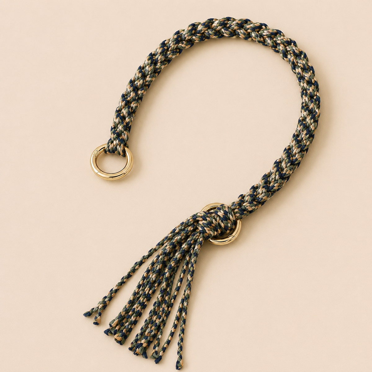 Navy, olive, and tan braided Sundaze phone strap with a fringed tassel and gold ring hardware.