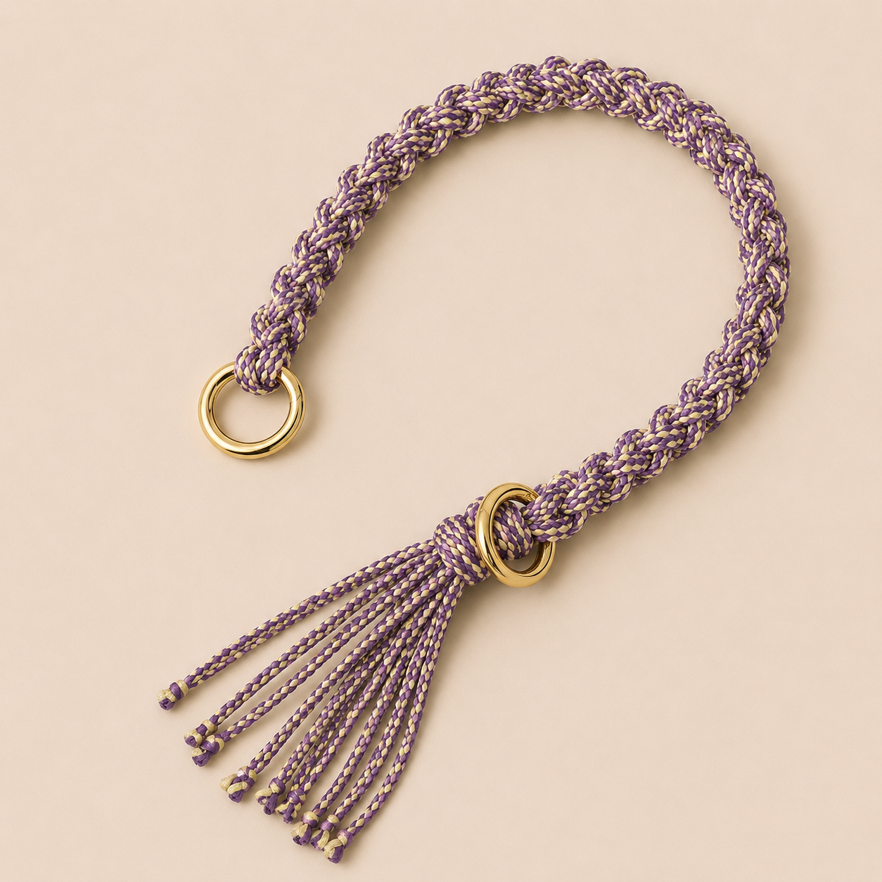 Purple and cream braided Sundaze phone strap with a fringed tassel and gold ring hardware.