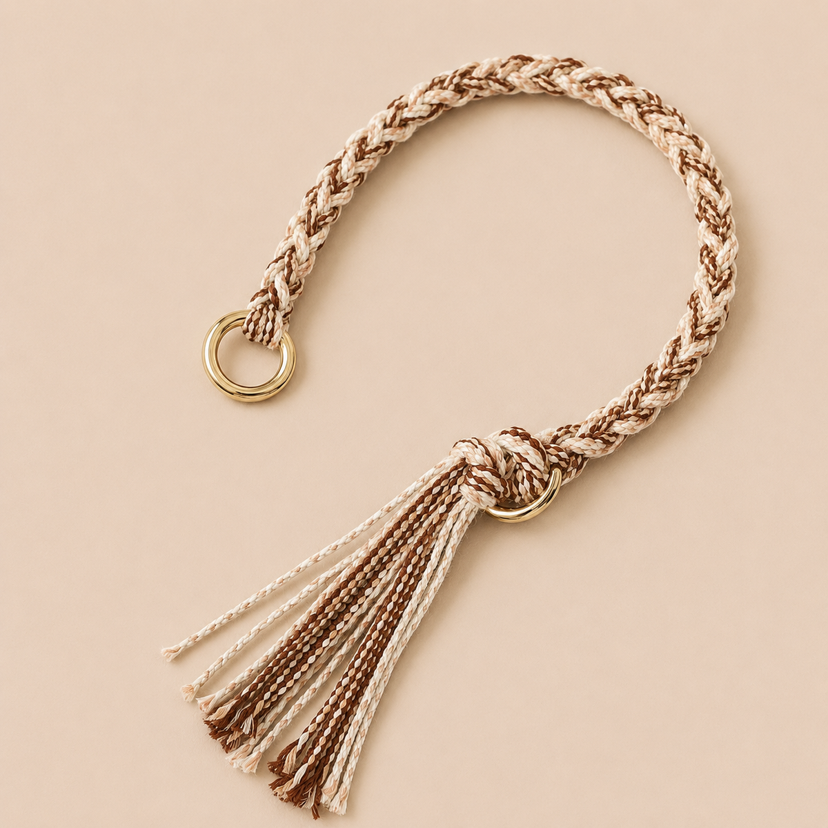 Brown and cream braided Sundaze phone strap with a fringed tassel and gold ring hardware.