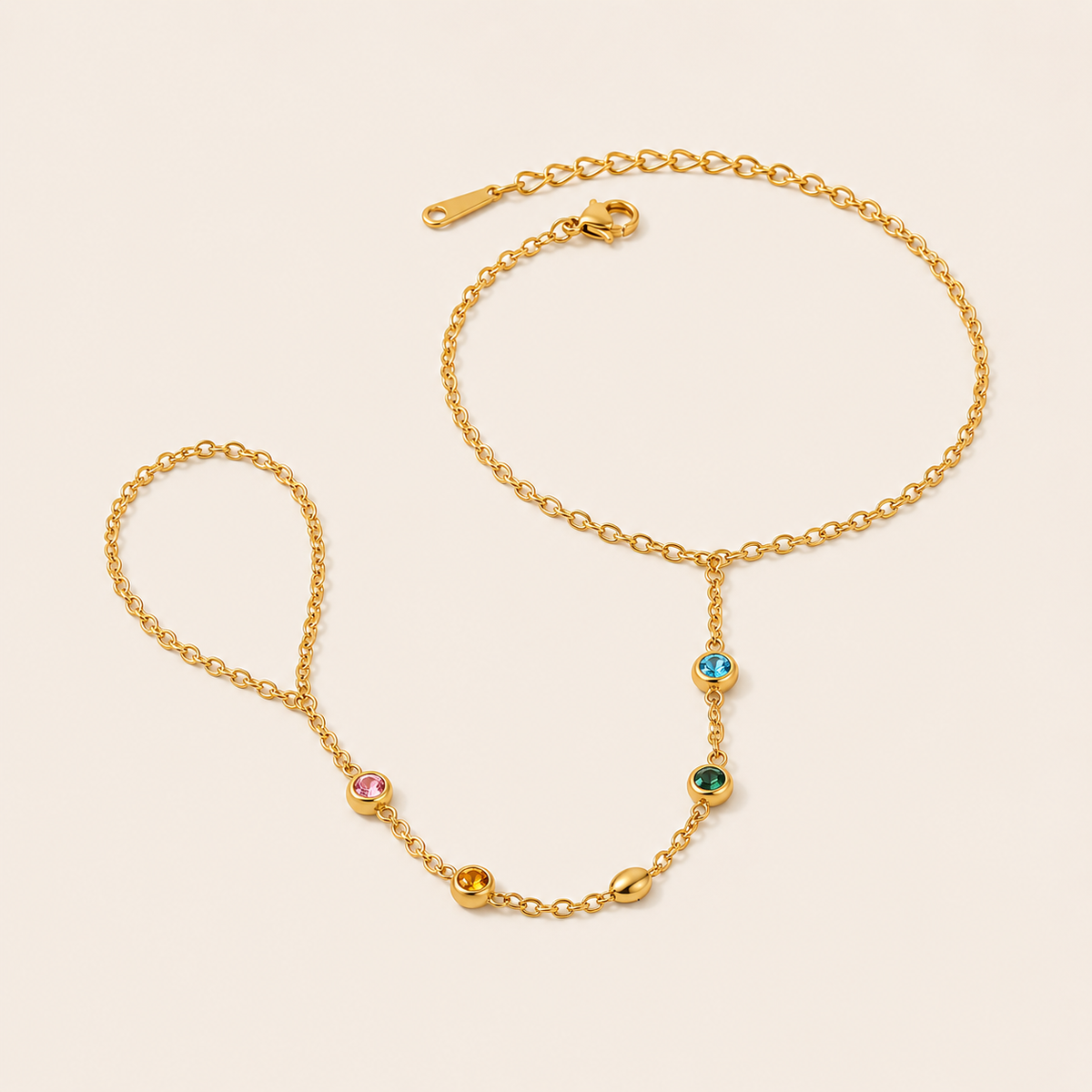Sunlit Hand Chain BRACELET in gold with multicolored gemstone stations linking the wrist chain to a ring, shown flat.