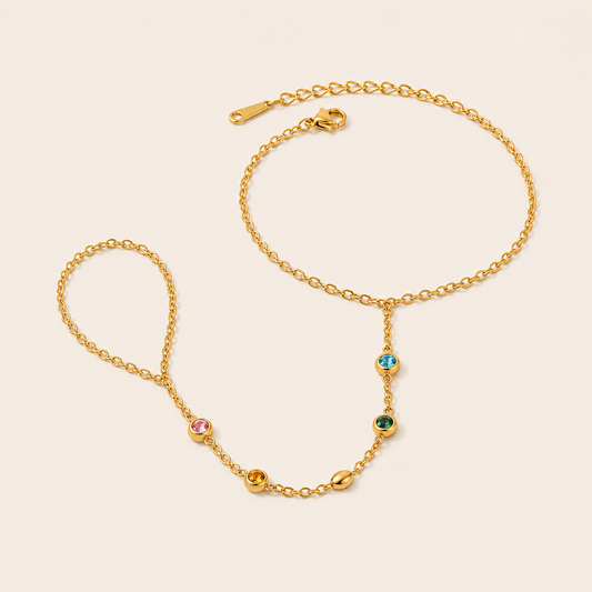 Sunlit Hand Chain BRACELET in gold with multicolored gemstone stations linking the wrist chain to a ring, shown flat.