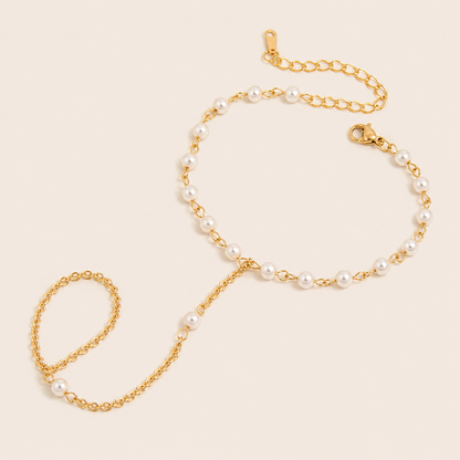 Sunseeker Hand Chain BRACELET in gold with small pearls beaded along the wrist chain and ring connector, shown flat.