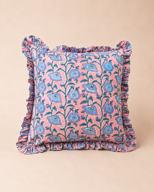 Pink square cushion with a blue floral vine block-print pattern and ruffled trim, the Taj Pink Square Cushion on a neutral background.
