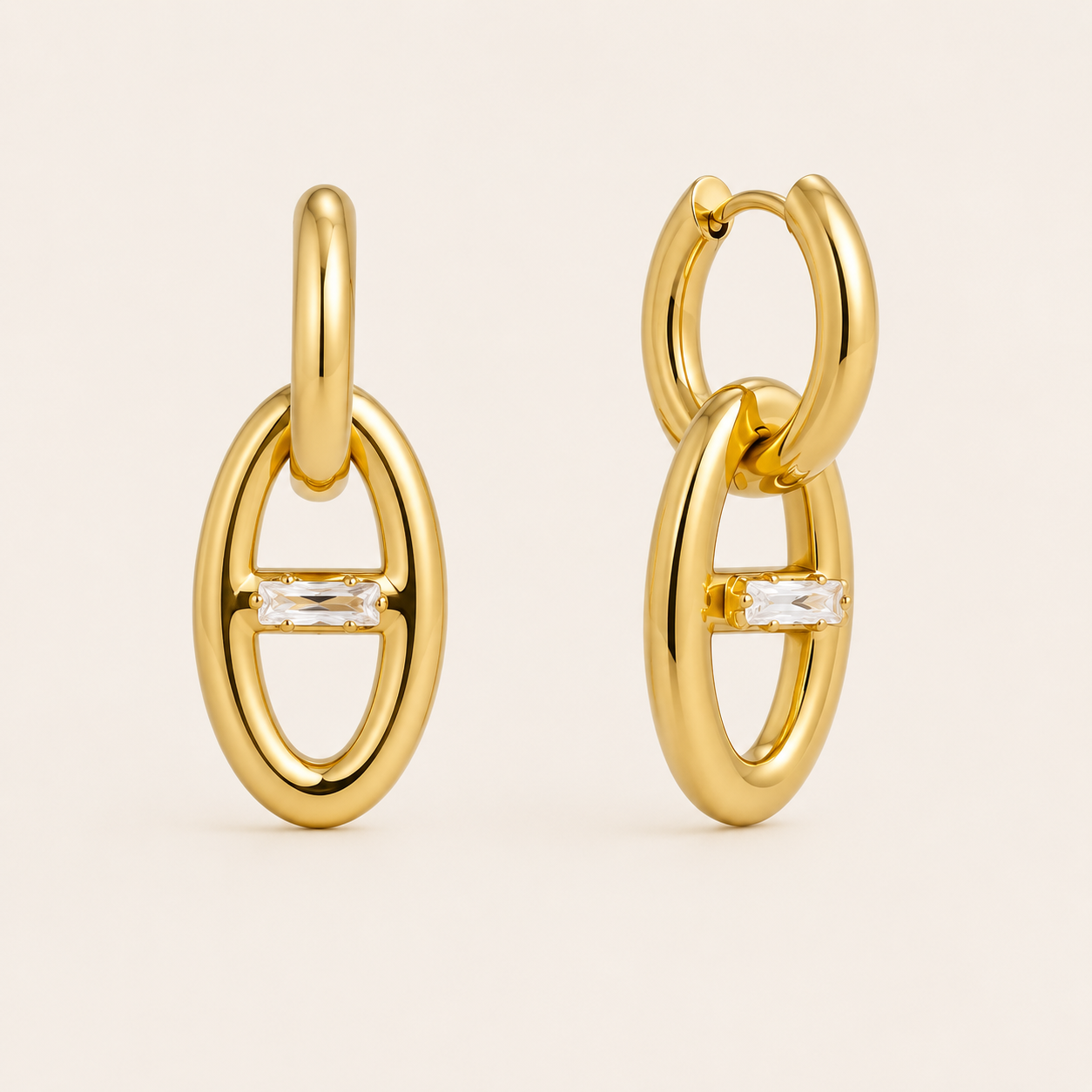 Gold oval link drop earring with a horizontal baguette-cut white zirconia stone at its center — Folie à Trois Talia EARRINGS.