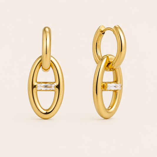 Gold oval link drop earring with a horizontal baguette-cut white zirconia stone at its center — Folie à Trois Talia EARRINGS.