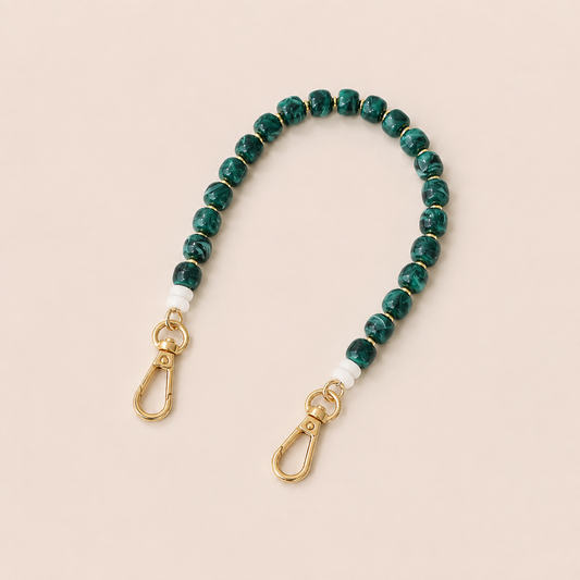 Green marbled bead phone chain with white spacers and gold clasps on cream — Folie à Trois Teagan wholesale phone chain