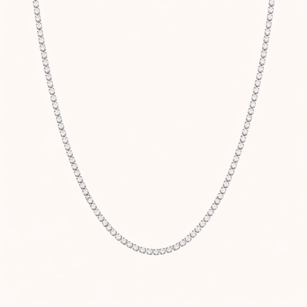 The Tennis NECKLACE in silver, a single row of round cubic zirconia stones set in a delicate chain, shown flat.