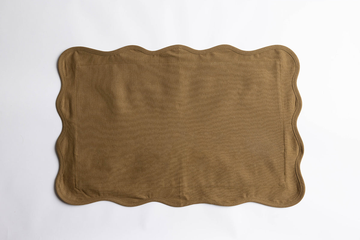 Flat lay of the Terry Rectangle Linen cushion in khaki-olive linen with a wavy scalloped edge on a plain white background.