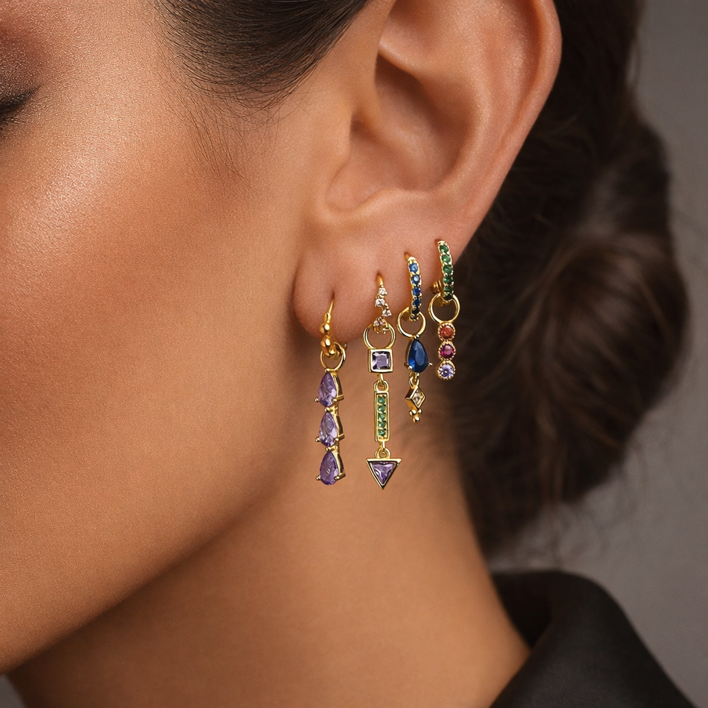 Tessa Set worn close on the ear, four gold huggies with pear, bar, and geometric gemstone drop charms.