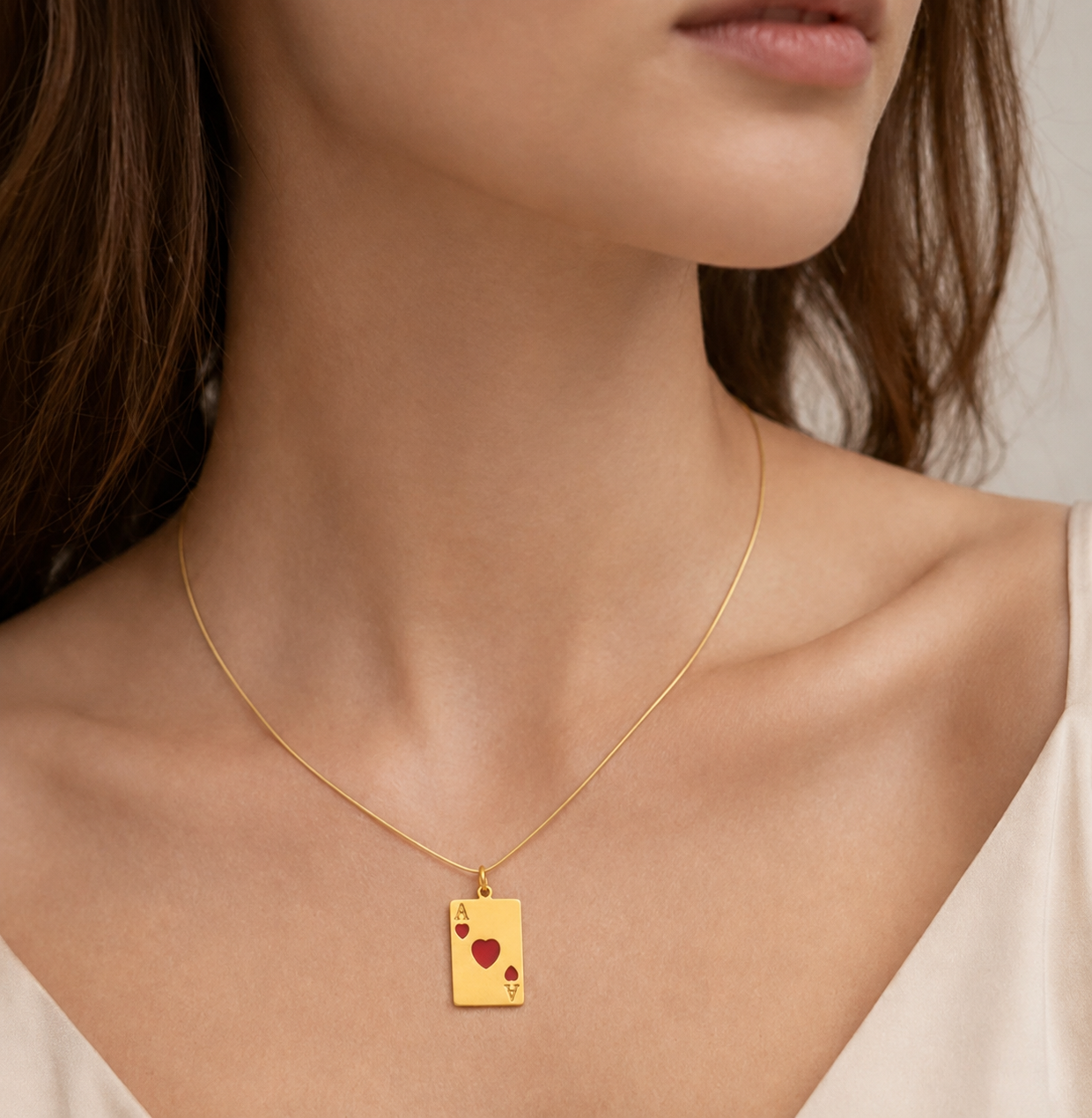 Gold ace of hearts card charm from the Signature Charms BUNDLE, enameled with red hearts, worn on a fine gold chain necklace.