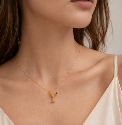 Gold martini glass charm with a green stone garnish from the Signature Charms BUNDLE, worn on a fine gold chain necklace.