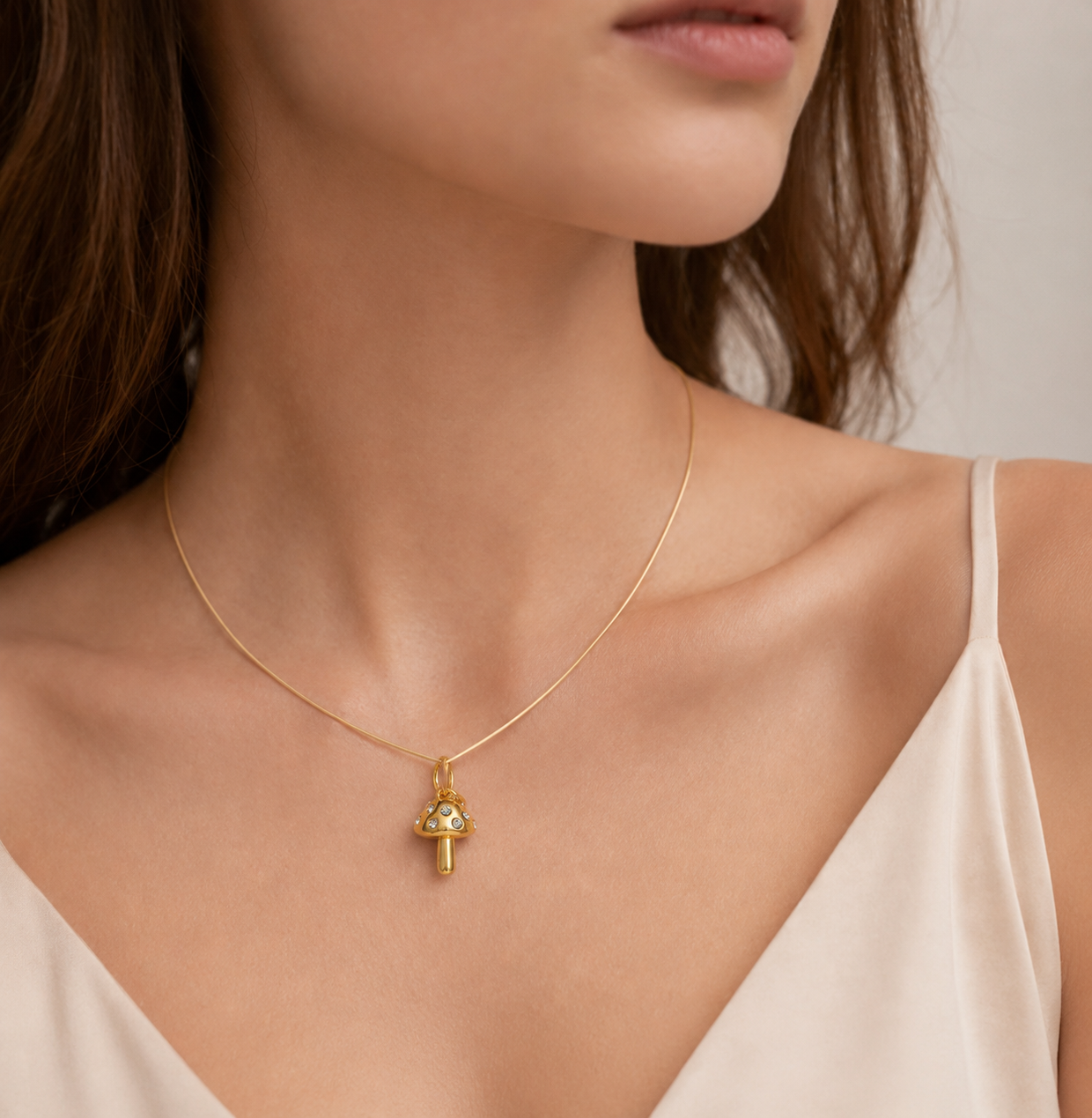 Gold mushroom charm set with tiny zircon stones from the Signature Charms BUNDLE, worn on a fine gold chain necklace.