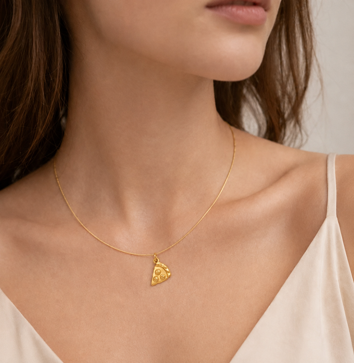 Gold pizza slice charm with textured toppings from the Signature Charms BUNDLE, worn on a fine gold chain necklace.