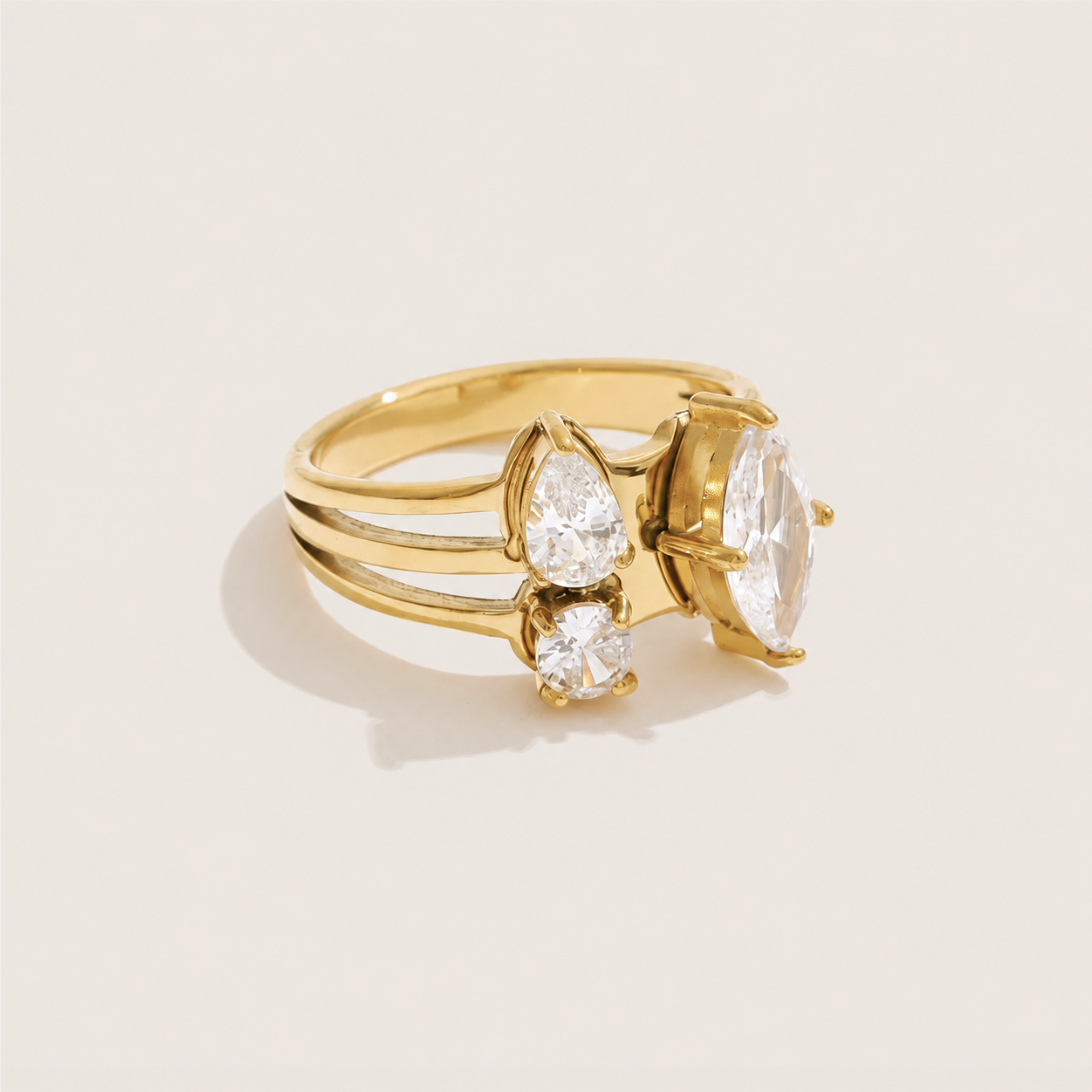 Gold split-band ring clustering a large marquise white zirconia with a pear and round stone — Folie à Trois Trio Halo RING