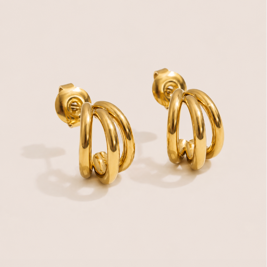 Gold triple-row huggie earring stud with three sleek stacked hoops — Folie à Trois Triplet EARRINGS.