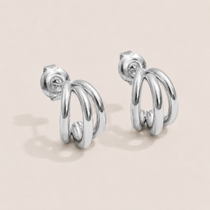 Silver triple-row huggie earring stud with three sleek stacked hoops — Folie à Trois Triplet EARRINGS.