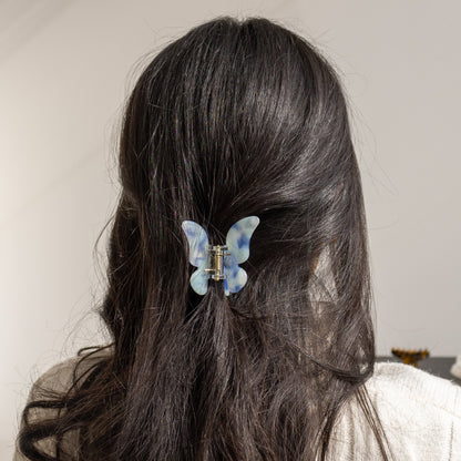 True Paradise HAIR CLIP's blue and white butterfly clip worn in half-up dark hair.