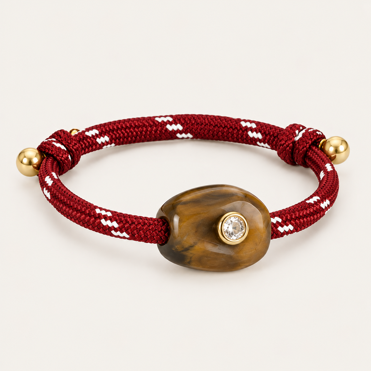 Truffle BRACELET in burgundy and amber: burgundy rope cord with a tiger's eye style stone and gold-set crystal, gold bead ends