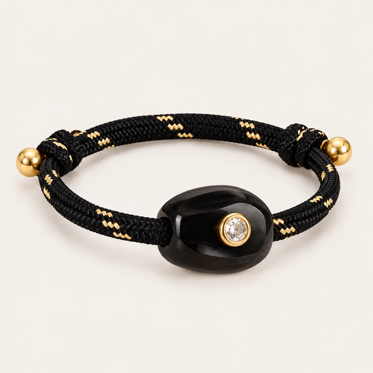 Truffle BRACELET in black: black and gold flecked rope cord with a glossy black onyx style stone and gold-set crystal