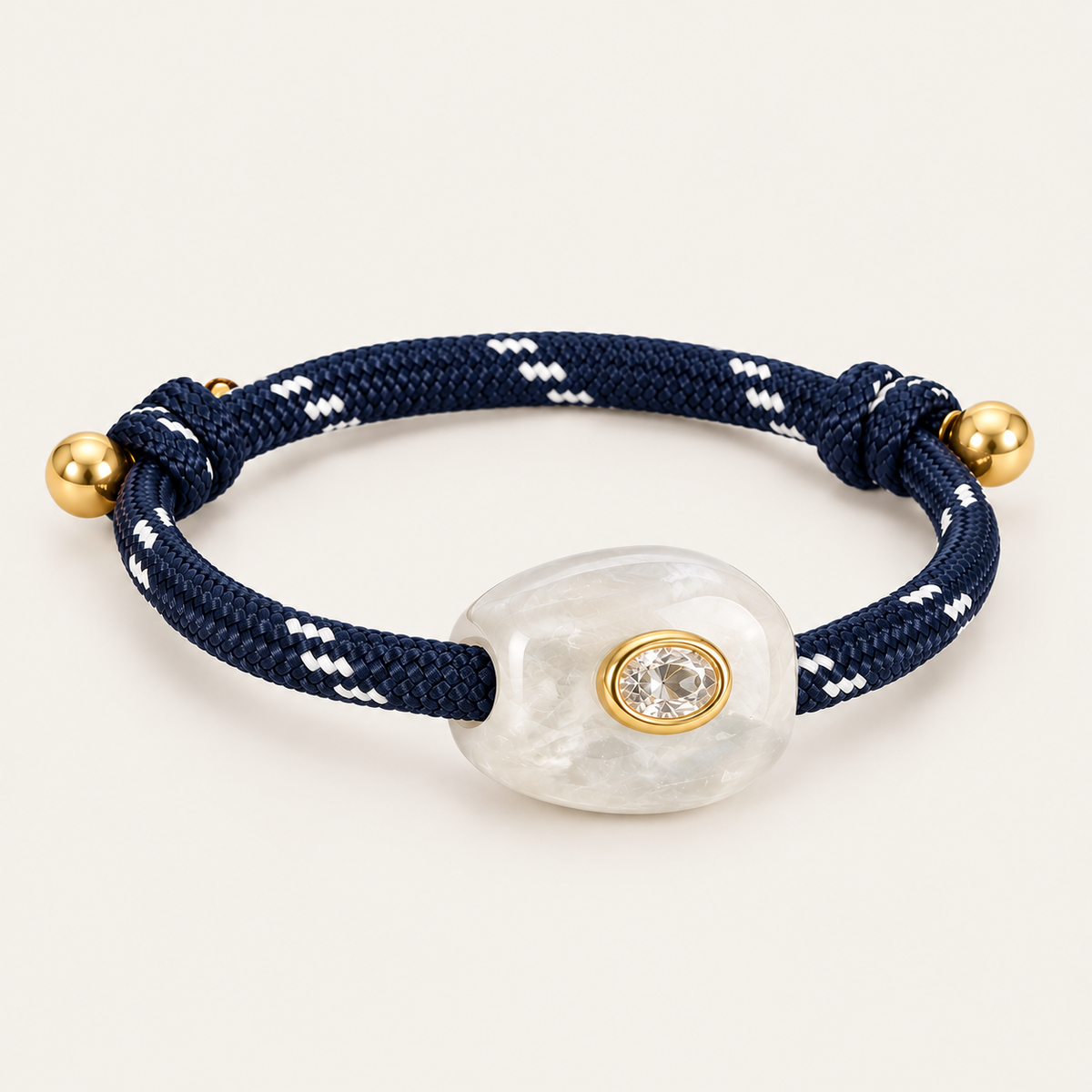 Truffle BRACELET in navy and clear: navy rope cord with a pearly white stone and oval gold-set crystal, gold bead sliding ends
