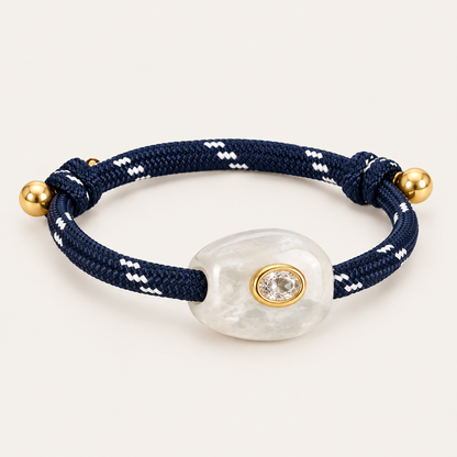 Truffle BRACELET in navy and clear: navy rope cord with a pearly white stone and oval gold-set crystal, gold bead sliding ends