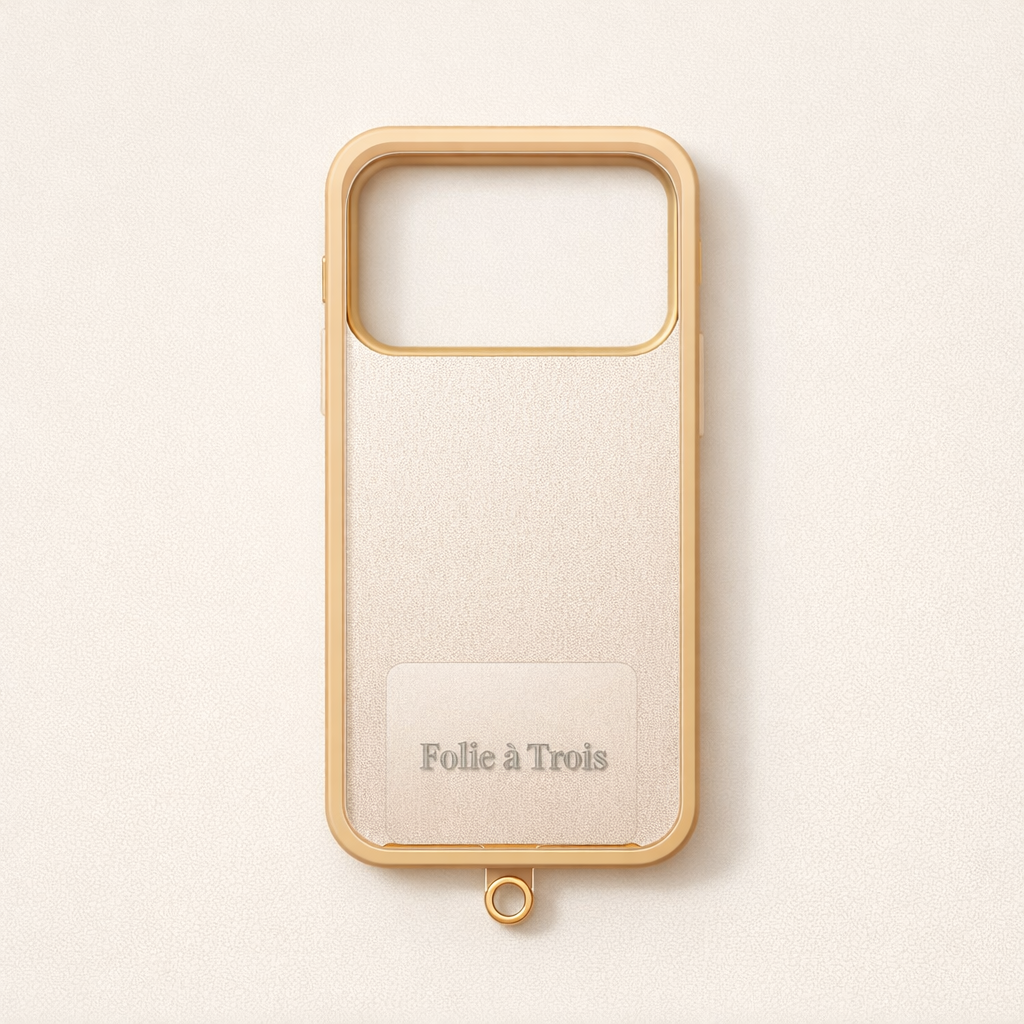Cream phone case with a gold-trimmed edge and a small gold attachment ring at the bottom, used with the Universal Phone Adapter.